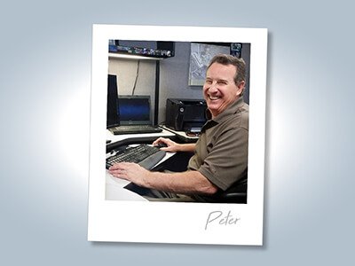 image of Peter at his desk smiling over his shoulder