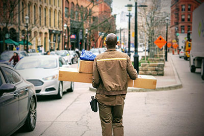 Delivery man carrying boxes
