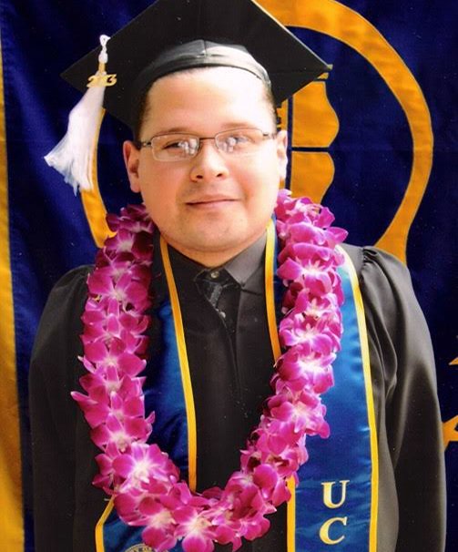 Image of Jesus at graduation wearing a cap and gown with flower lei around his neck